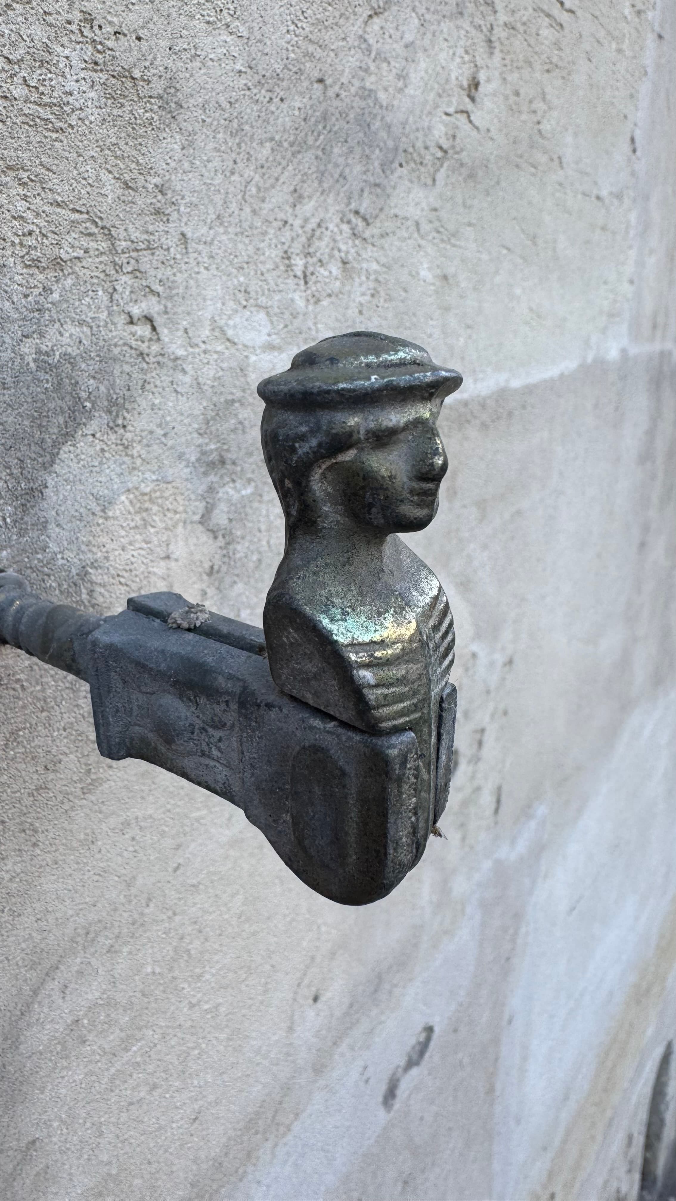 While walking down the street, I spotted this little guy on a concrete wall. Its purpose? To hold a window shade in place (while in ‘up’ position like shown on this image). So cute.
