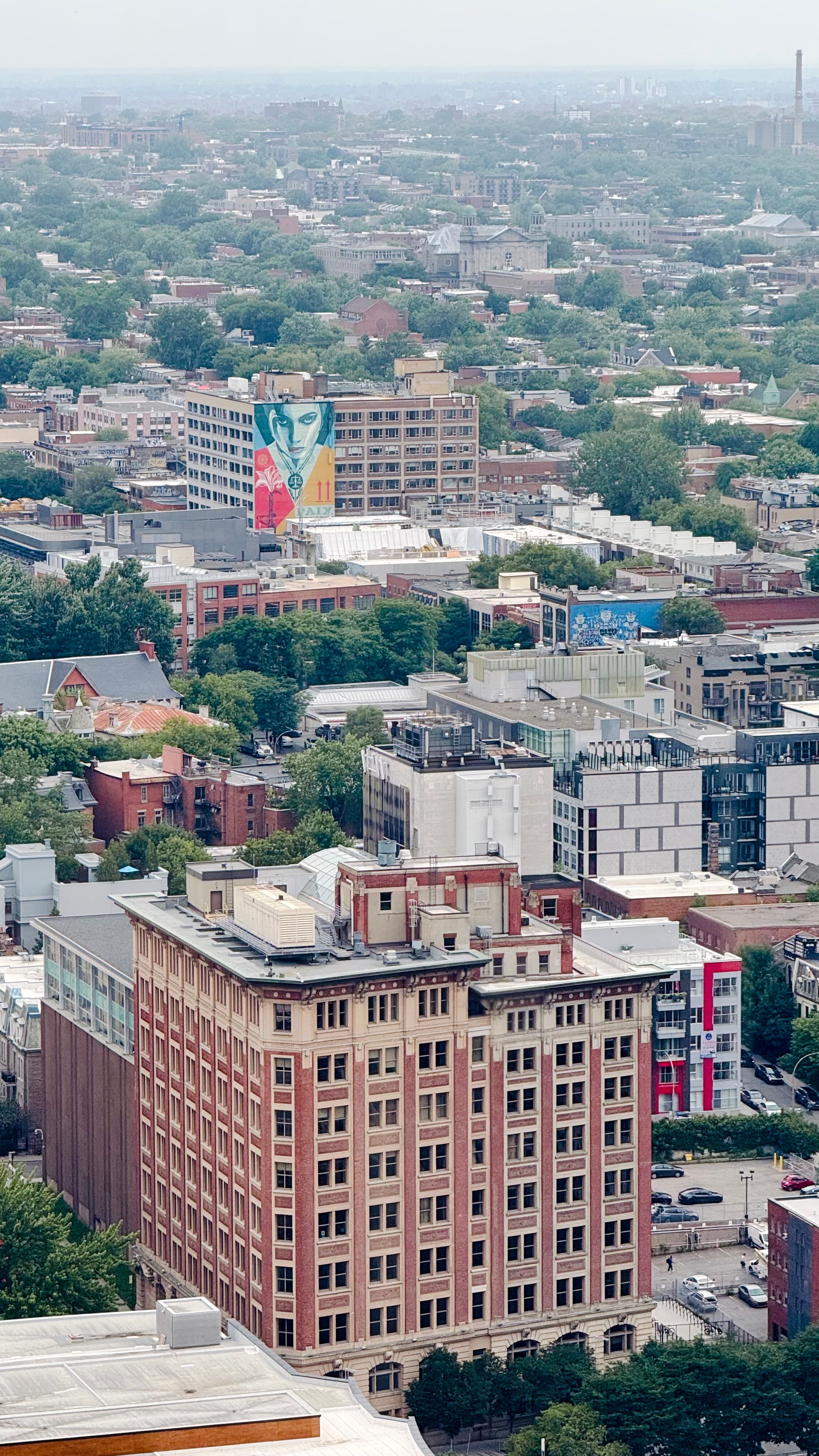 My office building offers a view of the Quartier des Spectacles, a vibrant area filled with festivals year-round. Notice the building with the painted woman's face, looking at me. Mesmerizing.